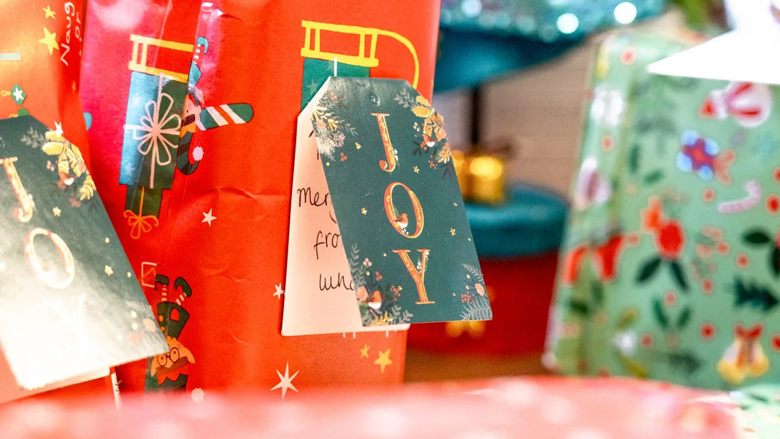 Wrapped holiday gifts with handwritten gift tags