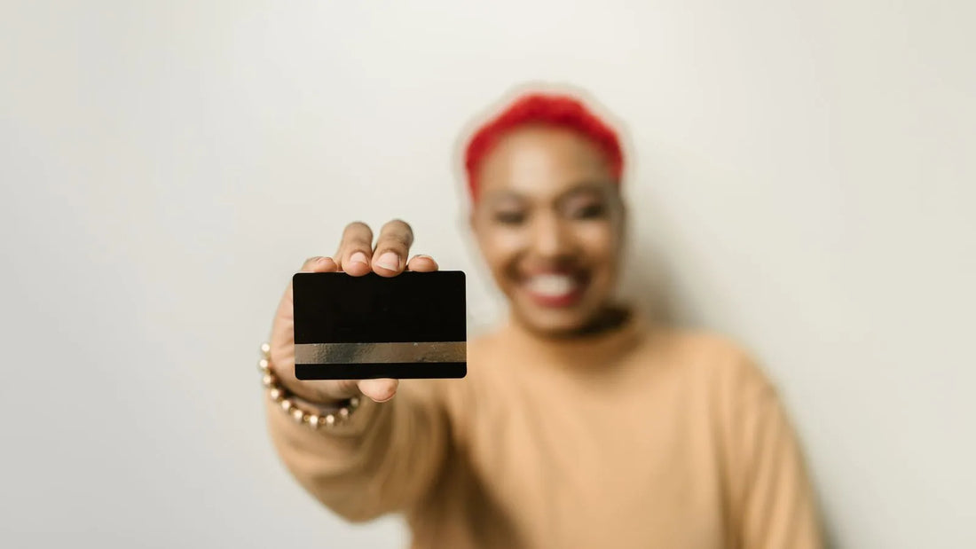 Person holding up a blank card with no visible numbers or logos