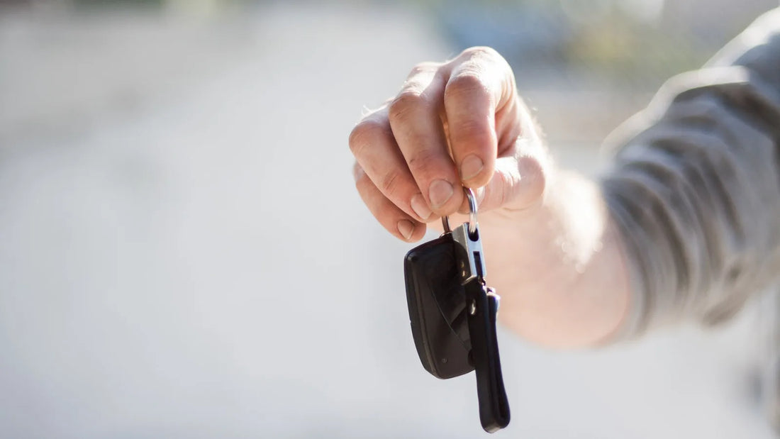 Hand holding up a car key