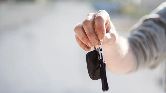 Hand holding up a car key