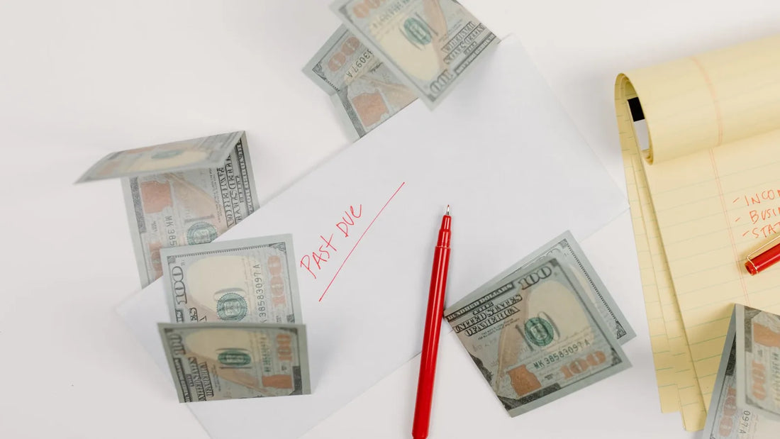 A "past due" envelope surrounded by cash and a notepad, representing the need to prioritize which debts get paid first